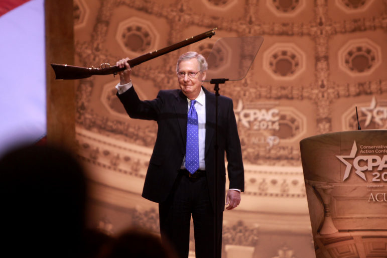 Mitch McConnell, who here appears to be surrendering his musket to an unruly crowd at the CPAC convention, is now the Senate majority leader. November 8 will determine whether he has to surrender that title as well.