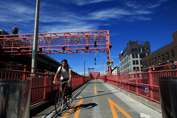 A cyclist crosses the Williamsburg Bridge.