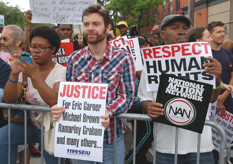 Protesters denounce the deaths of Eric Garner and Michael Brown at a Staten Island protest last summer.