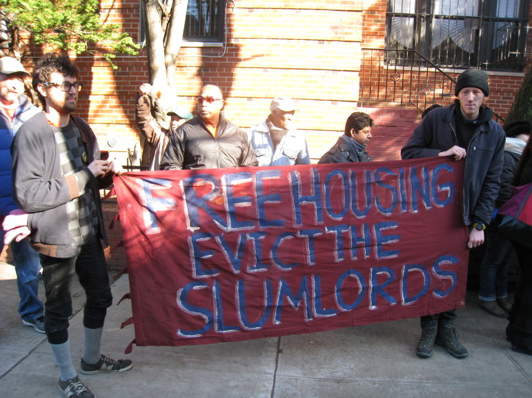 All of the protesters were Latino with the exception of four young white men who had recently moved into the neighborhood, and are residents in a collective house known as "Ma's House."  They held a sign that read "Free Housing, Evict the Slumlords."