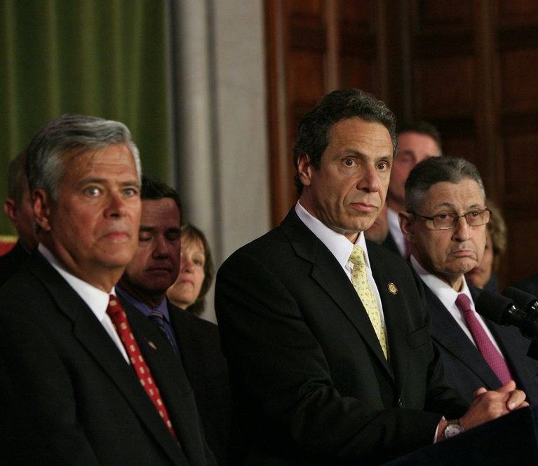 Gov. Cuomo seen in a 2011 photo with the two legislative leaders arrested on corruption charges this year, Dean Skelos at left and Sheldon Silver. Those arrests help set the stage for this week's last-minute drama.