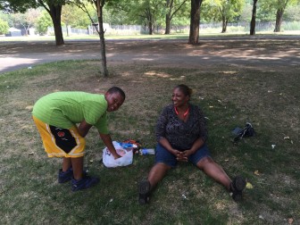 Prayer and play mixed for this grandmother and grandchild in Soundview Park. 