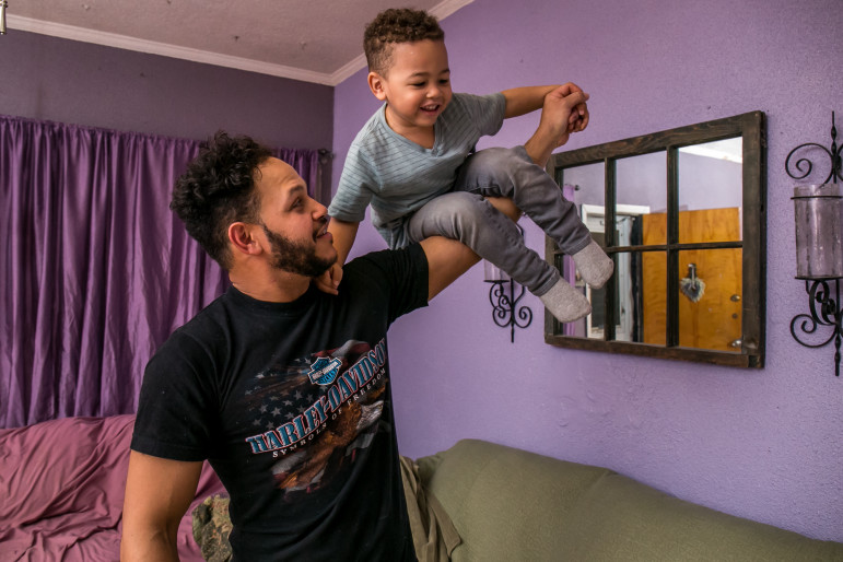 Alex Lora with his 3-year-old son, Alexander Lora III, at their residence in Queens, New York. Thanks to a city program that provided a lawyer for him, the elder Lora's immigration case set a new legal standard for others detained in the northeast.