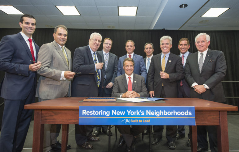 The governor seen earlier this week signing a bill to address so-called 'zombie properties.' Other housing matters, including most of his $1.9B housing plan, went unaddressed this session.