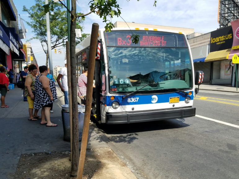 The Bx3 pulls up to the designated stop, and the waiting passengers board the bus and take an open seat.