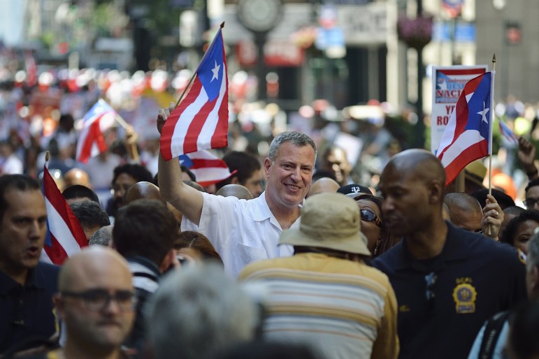Mayor Bill de Blasio marches in the Puerto Rican Day Parade on Fifth Avenue in June.
