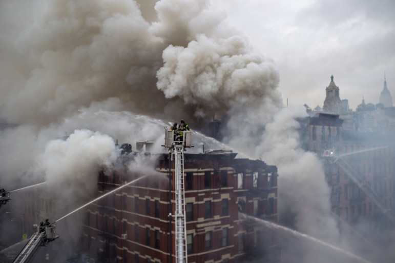 Firefighters battle flames after the March 26 explosion in the East Village, which killed two, injured 19 and destroyed three buildings.