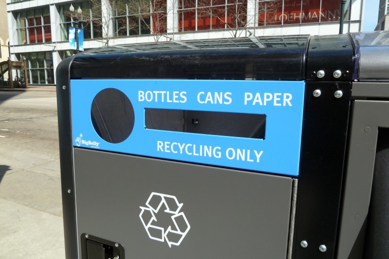 A single-stream recycling container in downtown Chicago. Eliminating the separation of paper from other recyclables tends to boost participation rates but can alter the economics of recycling.