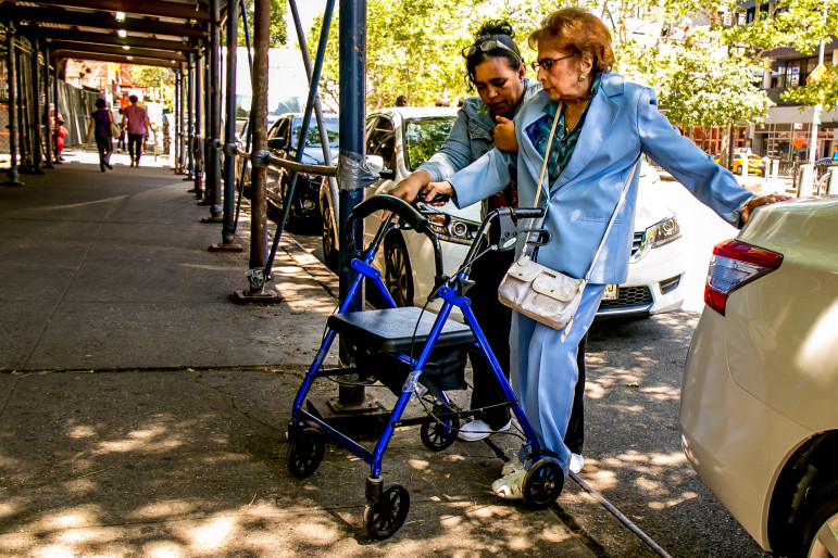 A senior citizen and a caregiver on their way to a senior center run by University Settlement on Allen Street in Manhattan. By 2030, one in five New Yorkers will be older than 60.
