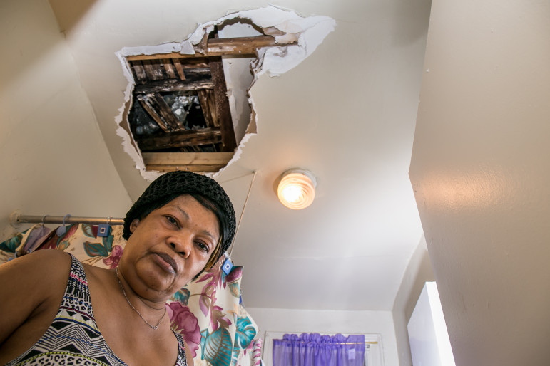 Marie Larochel in her apartment at 538 East 21st Street in Brooklyn, which she shares with her pregnant daughter. About a month ago, a water leak caused a hole in her bathroom ceiling.