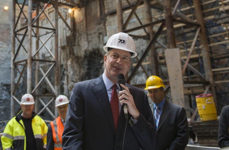 Mayor Bill de Blasio seen in late October delivering remarks at the groundbreaking ceremony for a mixed-use development at 20 Times Square.  Since his mayoral campaign, mandatory inclusionary zoning has been a key piece of his housing agenda.