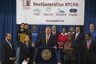 Olatoye flanks Mayor de Blasio at the rollout of NextGeneration NYCHA in May.
