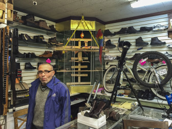 Michael Akhunov at his shoe repair shop in Ridgewood, Queens.