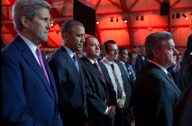President Barack Obama, Secretary of State John Kerry and other heads of state and delegations, observe a minute of silence for the Paris attack victims during the opening ceremony of the 21st Conference of the Parties to the United Nations Framework Convention on Climate Change (COP21), at the Parc des Expositions du Bourget in Le Bourget, Paris.