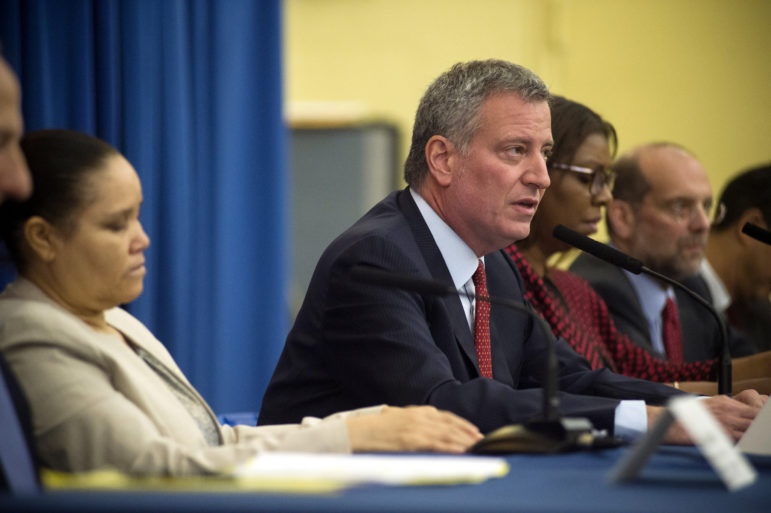 Mayor de Blasio, with Public Advocate Letitia James on his right and tenant Miguelanea Rincon on his left, announcing the new initiative.