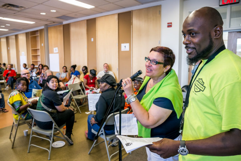Carmen Vega-Rivera, a tenant leader with Community Action for Safe Apartments, and Wayne Moten, a trade-union member and local resident, address an early August meeting about the pending Jerome rezoning.
