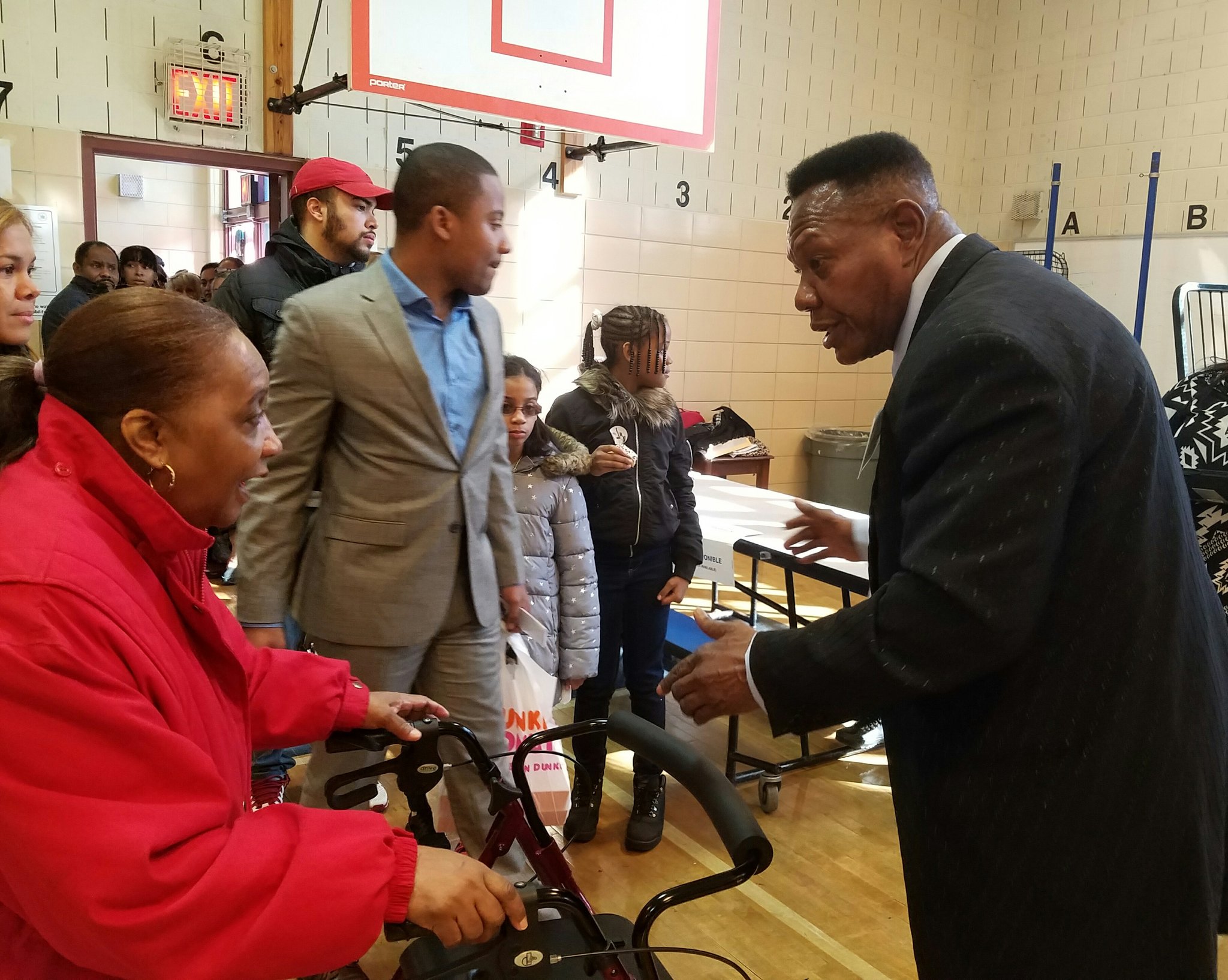 Poll workers Stevenson Nurse ushers the crowd of voters to each table, booth, and the exit.