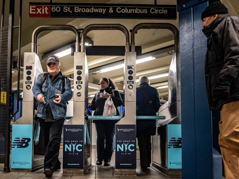 Paying the fare at the subway turnstile