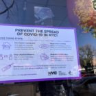 A sign in a Queens restaurant window urging New Yorkers to take COVID-19 precautions.