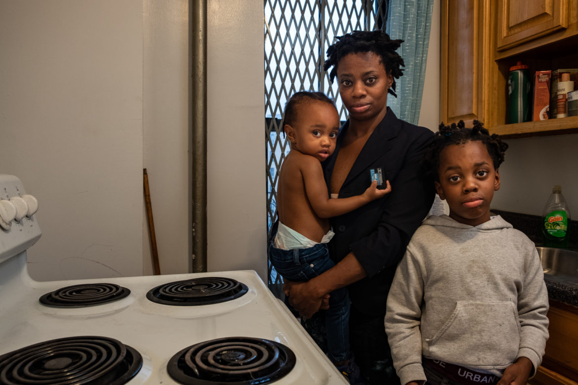 Bronx tenant and her two children in her apartment kitchen