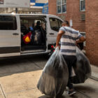 Possessions of migrant families who agreed to be relocated to other emergency shelter hotels being loaded into a van outside an emergency shelter hotel in Queens.