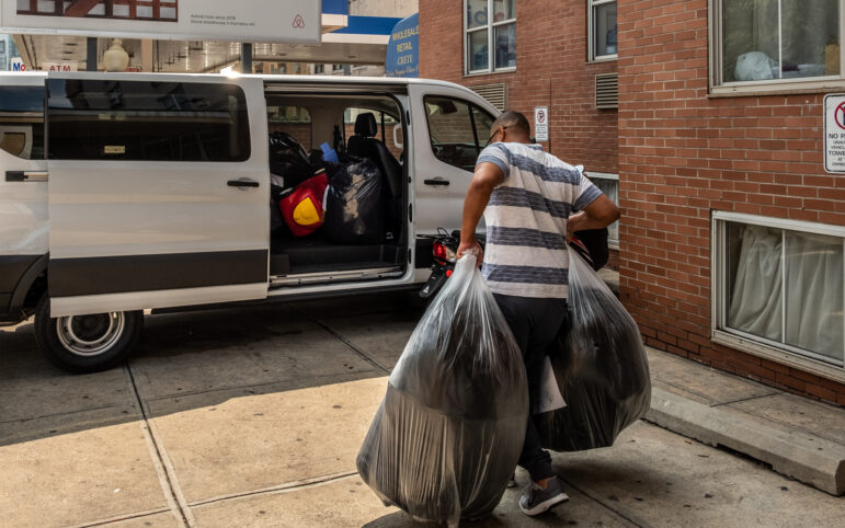 Possessions of migrant families who agreed to be relocated to other emergency shelter hotels being loaded into a van outside an emergency shelter hotel in Queens.